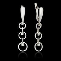 White gold earrings with diamond isolated on the black background photo