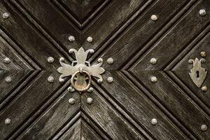 Wooden door with iron handles. Ancient wooden door. Detail of a wooden background. photo