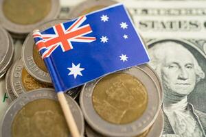 Stack of coins with Australia flag and US dollar banknotes. photo