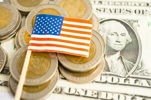 Stack of coins with USA America flag and US dollar banknotes. photo