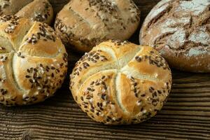 Different bread on a rustic wooden background. Bakery assortment of bread. photo