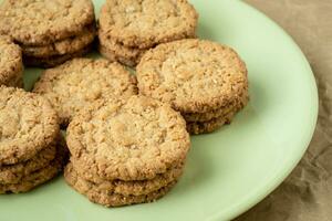 Tasty cookies biscuits. Stack of sugar cookies biscuits in green plate. photo