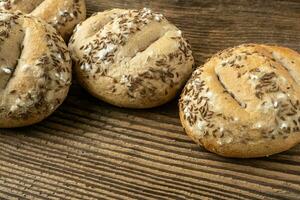 Bread rolls sprinkled with salt and caraway. Bakery assortment of bread. photo