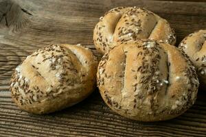 Bread rolls sprinkled with salt and caraway. Bakery assortment of bread. photo