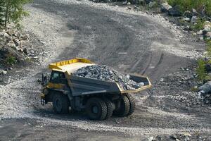 Dump truck in limestone mining, heavy machinery. Mining in the quarry. photo