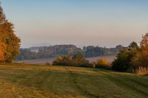 Beautiful hilly autumn landscape. Autumn leaves in forest. Czech republic photo