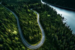 ai generado aéreo ver de un la carretera devanado mediante un denso bosque y corriendo junto a un lago foto