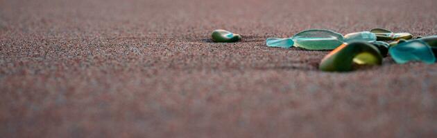 Mediterranean sea beach and colorful stones photo. Glass stones from broken bottles polished by the sea photo
