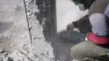 worker at a construction site cuts concrete with a grinder video