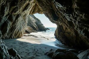 AI generated the beach from the inside of a large, rock cave photo