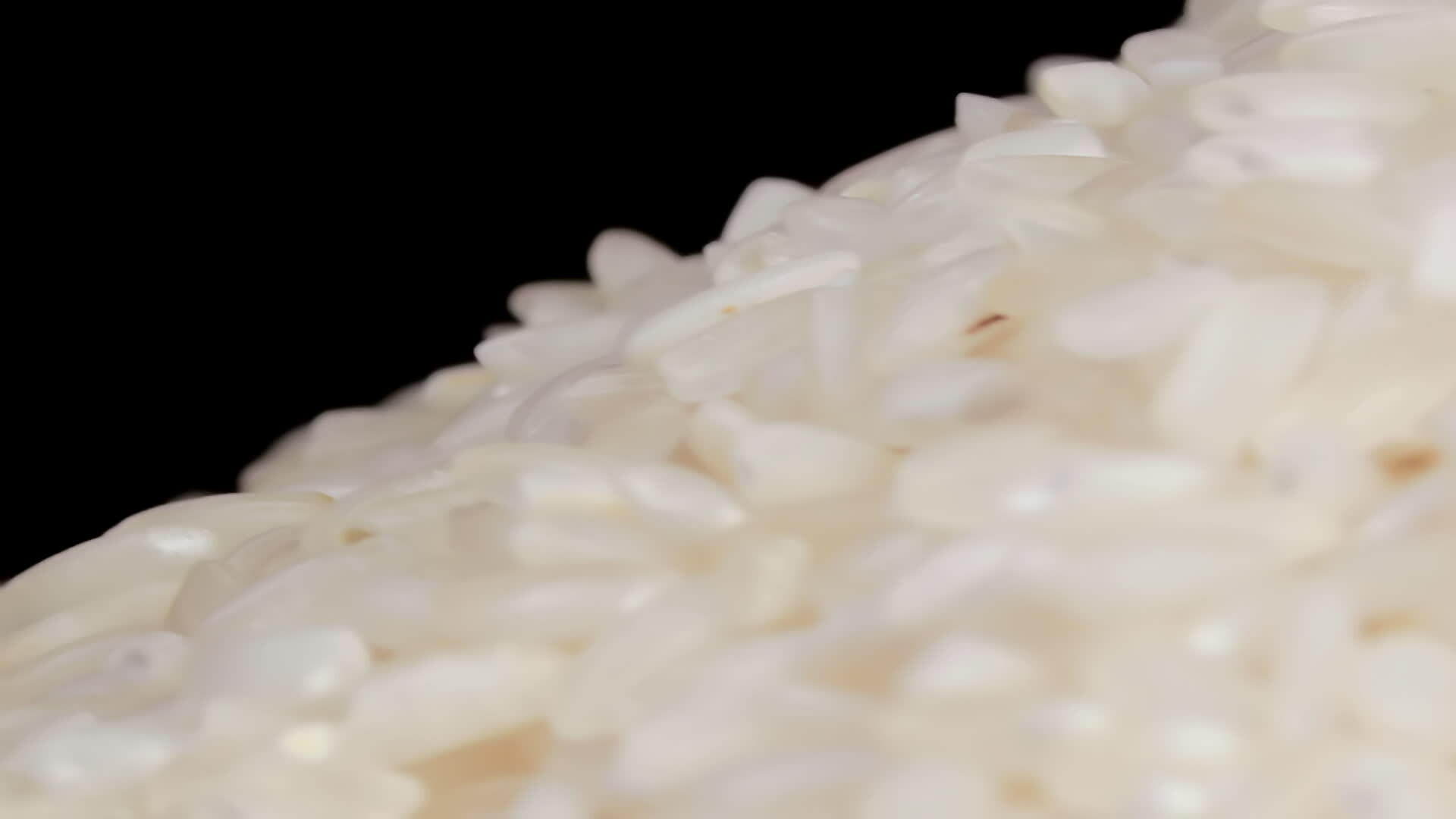 Dry Uncooked White Rice Heap Rotating Macro. A Pile of Raw Long Grain