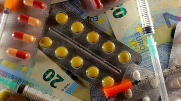 Inflation. Expensive Medicine. High Cost of Healthcare. Global Pharmaceutical Industry and Medicinal Products. Different Pills and Syringes on the Twenty Euro Banknotes - Top View, Slow Rotation Left video