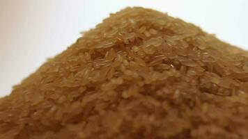 Dry Uncooked Parboiled Rice Heap Rotating against White Background. A Pile of Raw Long Grain Rice. Asian Cuisine and Culture. Healthy Eating Ingredients. Diet Food video