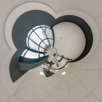 abstractly twisted into a spherical 360 panorama interior of a modern office with a hall staircase and panoramic windows photo