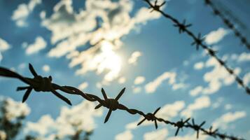 AI generated Barbed wire in front of blue sky with cloud photo