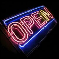 AI generated Neon vibrant OPEN text sign isolated on black photo