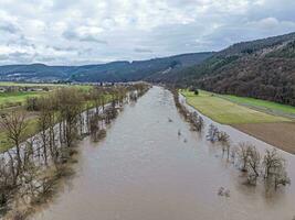 Drone image of the German river Main during a flood with flooded trees on the banks photo