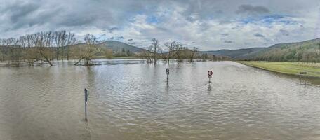 Drone image of the German river Main during a flood with flooded trees and traffic signs on the bank photo