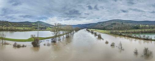 Drone image of the German river Main during a flood with flooded trees on the banks photo