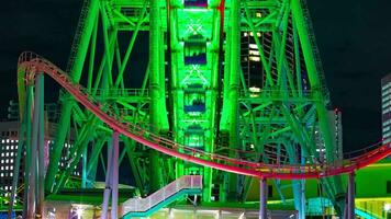 A night timelapse of rotating ferris wheel in Yokohama telephoto shot zoom video