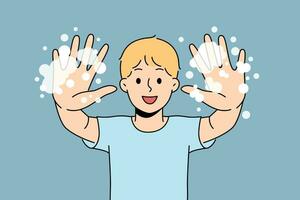 Little boy with foam shows soapy palms, recommending washing hands and following hygiene rules. Happy teenage boy doing preventive diseases and using soap after returning from school or walking vector