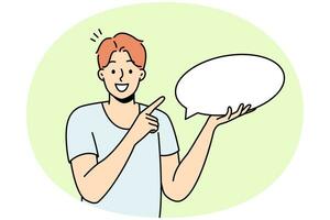 Smiling young man holding speech bubble in hands. Happy guy point at mockup empty blank copy space for advertising. Vector illustration.