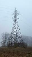 Foggy morning. High voltage towers in the morning fog photo