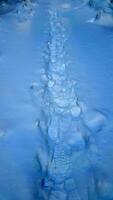 Footprints in the snow. Snowy surface with human traces. Winter landscape photo