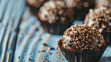 AI generated Brigadeiro in paper forms on blue wooden background, close up photo