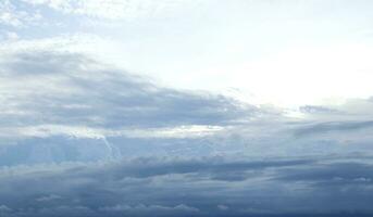 Gray clouds cover white and bright sky background. photo