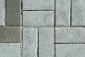 Grey concrete paving slabs. Texture of gray paving slabs. photo