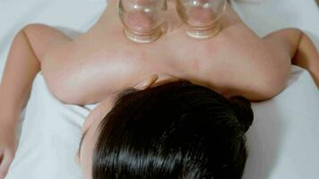 Beautiful Woman Received cupping treatment on back by  therapist, chinese medicine treatment, health and healing concept. video