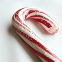 AI generated A striped red and white candy cane for a food-themed isolated on a white background. photo