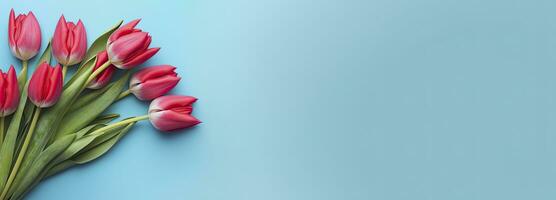 AI generated Bouquet of red tulip on blue Background. Top view with copy space.  AI Generated photo