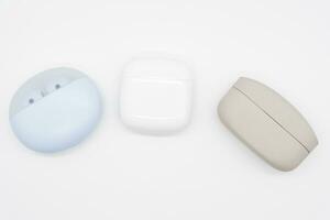 Different types of Truly wireless earphones with charging case. photo