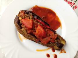 Turkish Food known as karniyarik, makes with meat and aubergine photo