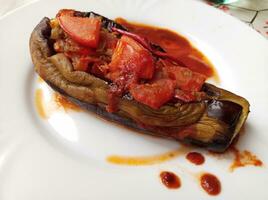 Turkish Food known as karniyarik, makes with meat and aubergine photo