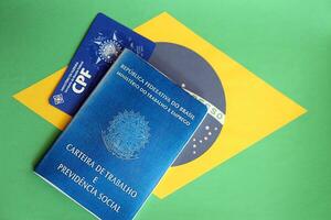 TERNOPIL, UKRAINE - JULY 7, 2023 Brazilian Work Permit document and Brazilian tax number card on table photo