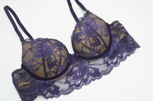 Lingerie. Beautiful sexy lace purple lilac bra on a white background. Fashionable colored women's underwear. photo