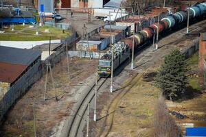 Freight train traveling through the city buildings. photo