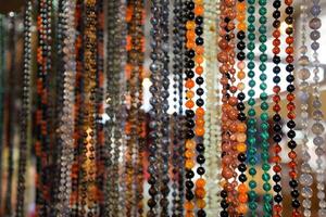 Indian beads and jewelry on the counter in store. photo