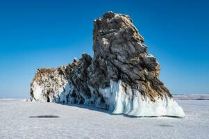 Spectacular landscape of the Dragon tail rock located at Ogoy island in frozen lake Baikal in winter season. photo