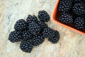 Fresh blackberries on stone photo