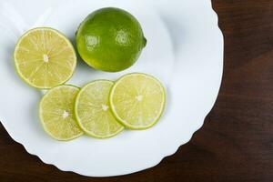 White plate with slices of lemon photo