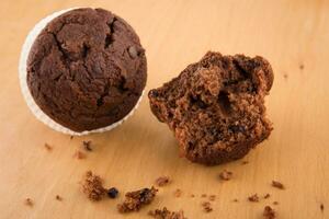 Chocolate chip muffin on wood table photo