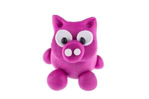 Pig from plasticine isolated on white background photo