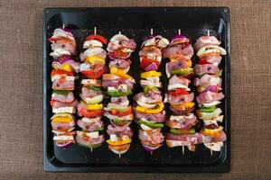 Raw pork skewers ready for grilling photo