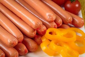 Close up of raw frankfurter sausages on white plate photo