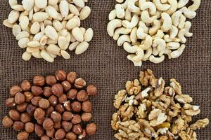 Almonds, cashew, walnuts and hazelnuts lying on burlap photo