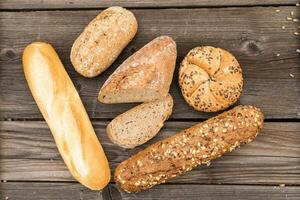 Background of fresh bread and bakery on an old vintage planked wood table. photo